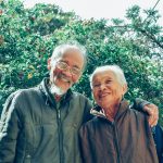Smiling Man and Woman Wearing Jackets
